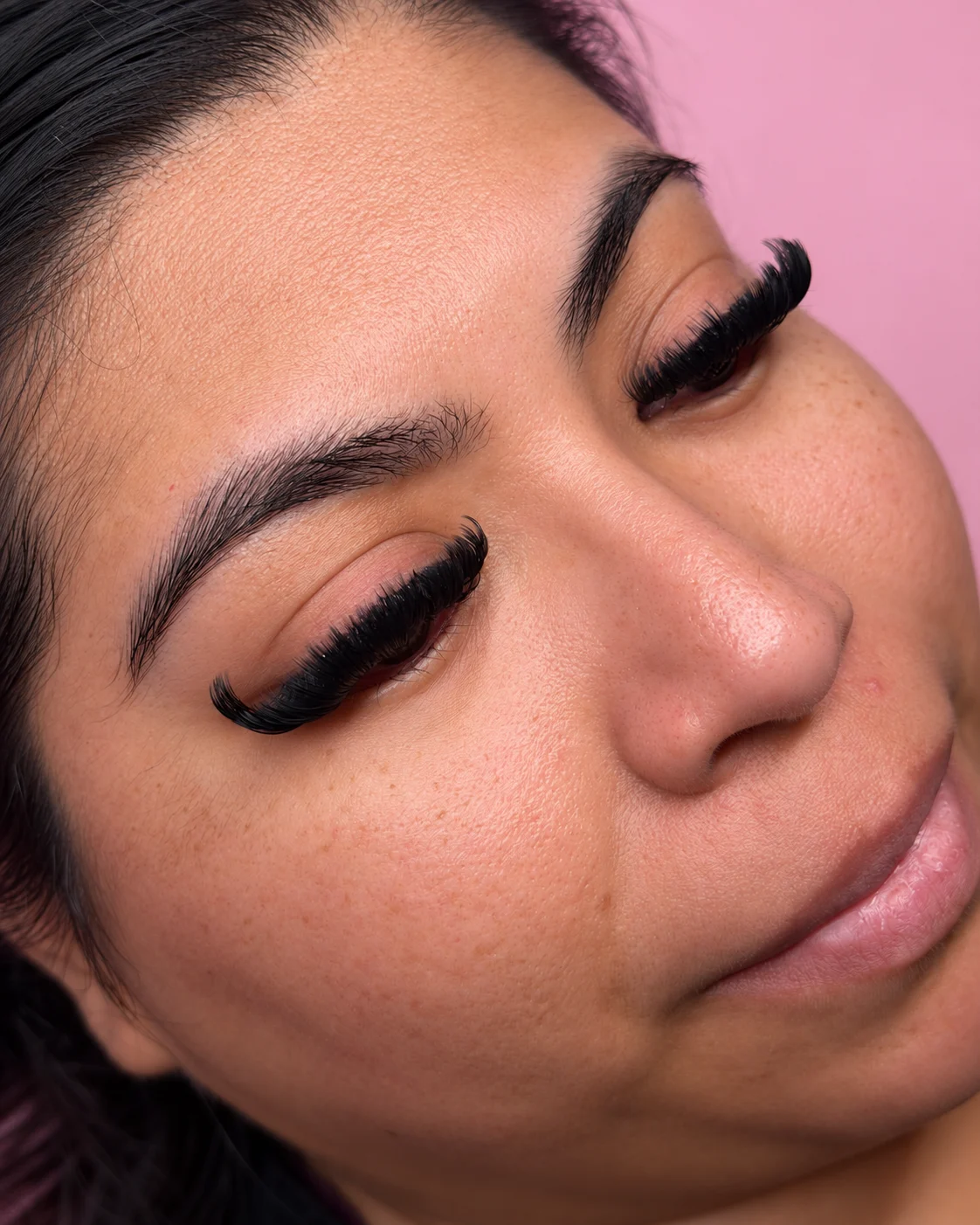 Close-up of a full lash set on a client with her eyes closed